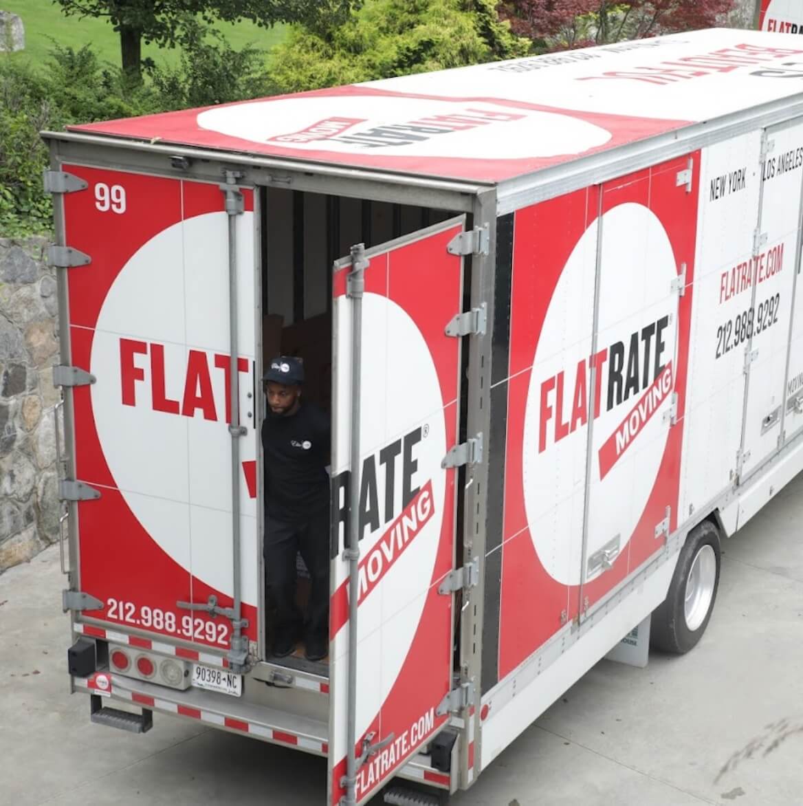 Flatrate delivery truck with rear door open, ready for art storage or transportation