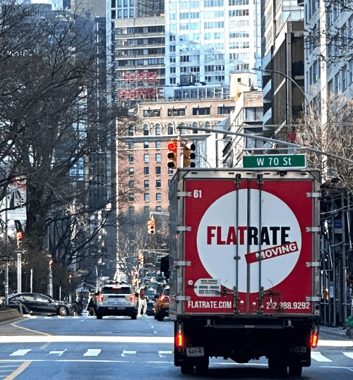 Flatrate truck driving through NYC