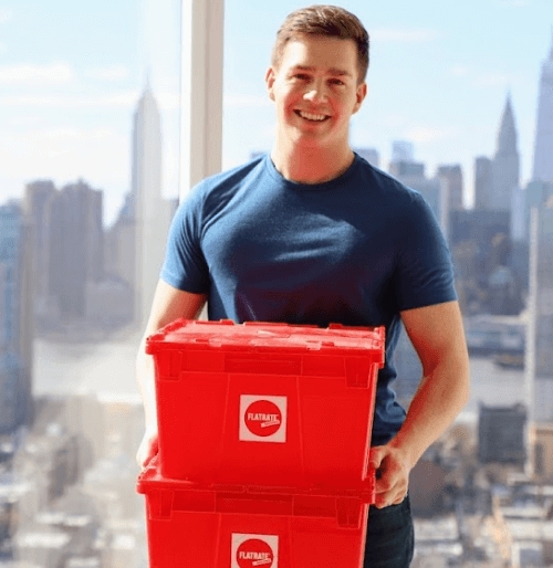 Young man holding red plastic boxes