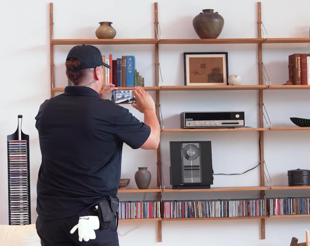 Flat rate worker taking photograph of room to use in room replication